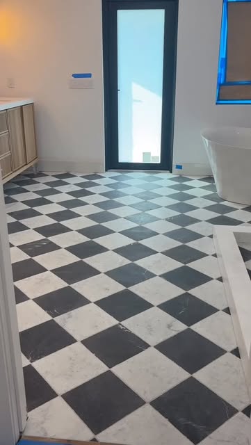 Black and white marble checkerboard floor running down a hallway