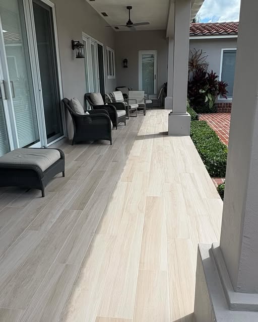 Light wood-look porcelain plank floor on a long covered porch