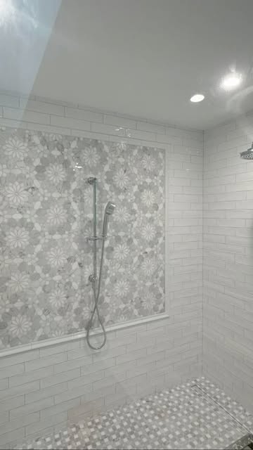 Walk-in shower with a mosaic accent panel framed in white subway tile